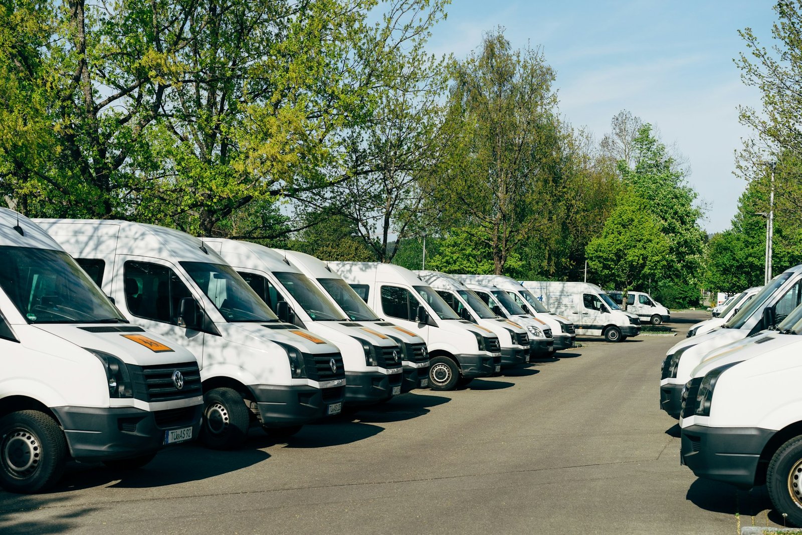 A row of white commercial work vans